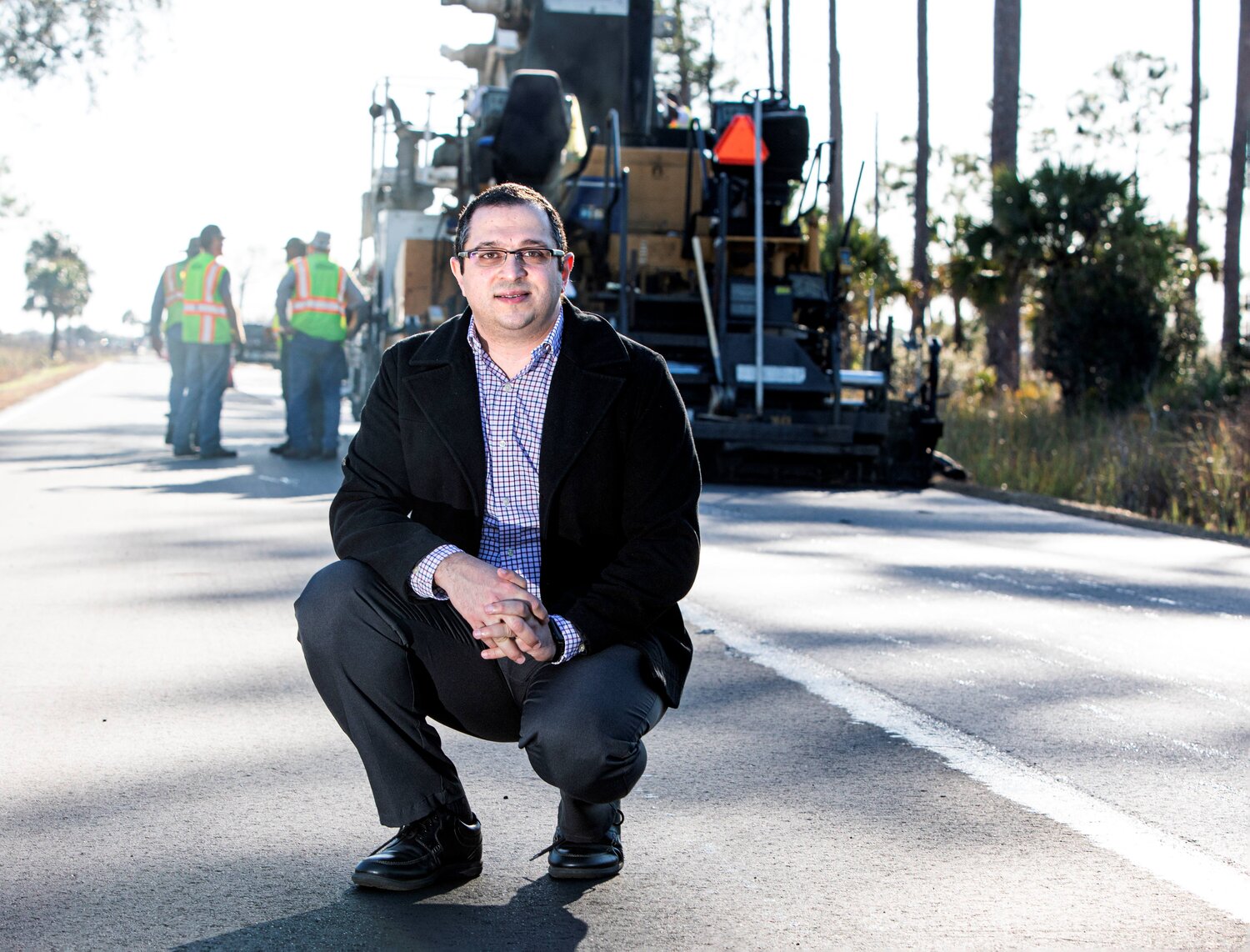 Dr. Elwardany on a road with workers in the background