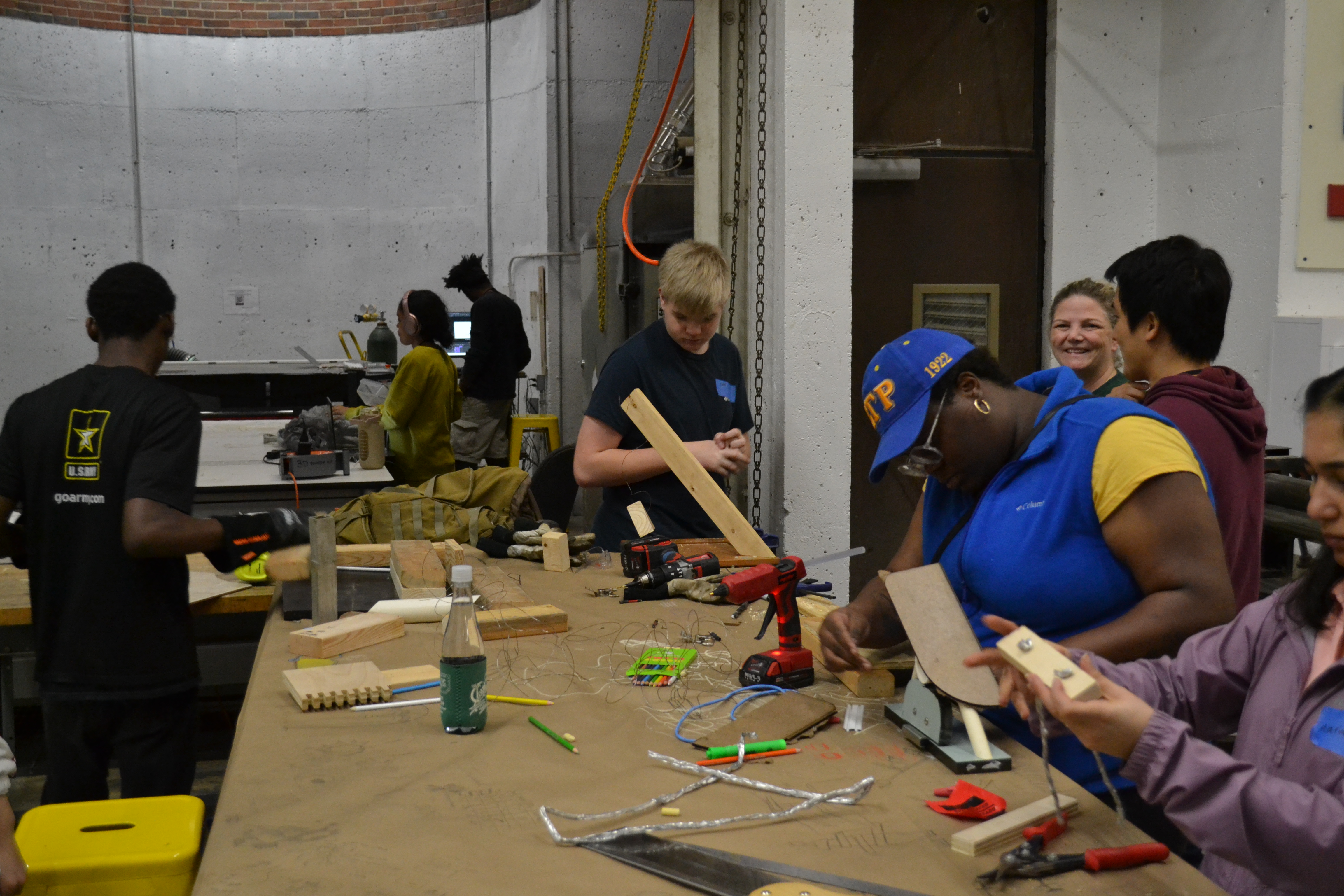 Middle schoolers transforming trash into art at the 'Art to Trash' event, guided by Dr. Choi and Mr. Duarte.