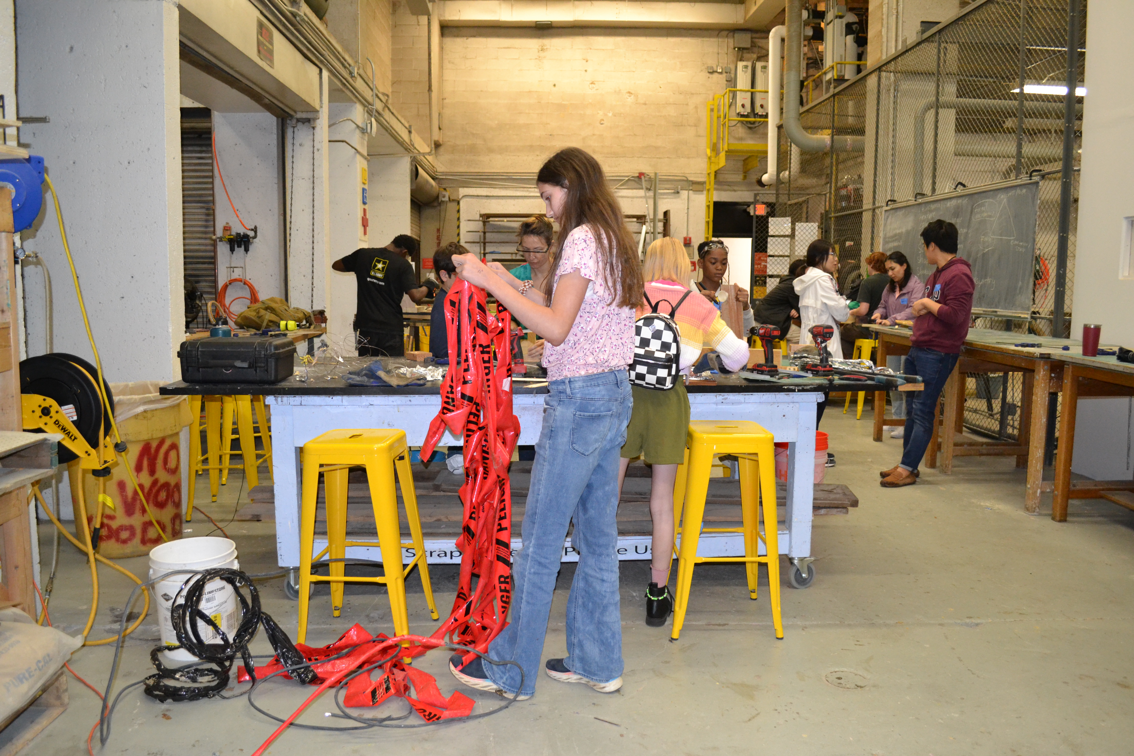 Middle schoolers transforming trash into art at the 'Art to Trash' event, guided by Dr. Choi and Mr. Duarte.