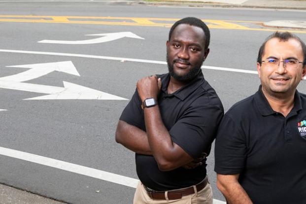 Dr. Eren Ozguven and PhD student Richard Antwi photographed together on highway