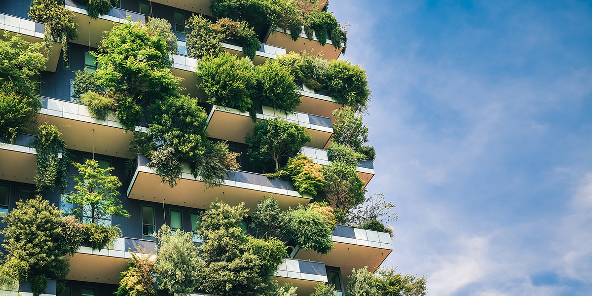 photo of high rise building with plants on balconies